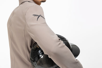 Close up of beige Men's Freejump Show Jacket with dragonfly emblem on right shoulder