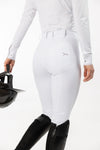 Back of White Women's Freejump Breeches with perforated back pockets and dragonfly emblem on right pocket, and silicone “Griptec” technology on inside leg