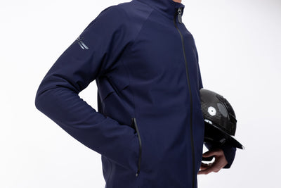 Close up of Pluto Navy Men's Freejump full zip Rain Jacket with zipper front pockets and dragonfly emblem on right shoulder.