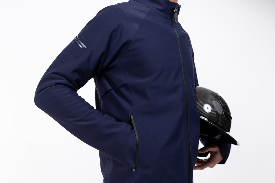 Pluto Navy Men's Freejump full zip Rain Jacket with zipper front pockets and dragonfly emblem on right shoulder.