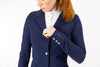 Close up of neptune blue Freejump Women's Show coat to show "freejump" on left sleeve and Laser-cut perforated bands on the bottom of the pockets and on the collar