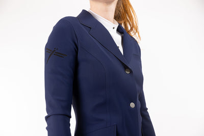 Close up of neptune blue Freejump Women's Show coat to show dragonfly emblem on right shoulder
