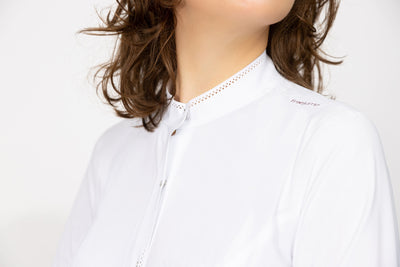 Close up of White Long Sleeve Freejump riding shirt to show White Long Sleeve Freejump Women's Riding shirt with laser cut perforated bands on the top of the collar, and "freejump" on left collar bone