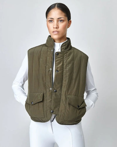 The Green Quilted Riding Vest offers a boxy silhouette with a stand-up collar, front zipper, and placket with easy press studs. The exterior is both wind-proof and water-repellent while Primaloft Padding insulates to provide optimal warmth throughout your ride. Feature two front pockets, two invisible side seam pockets, and an inner pocket. Cut from an Italian fabric, and sewn in Europe.