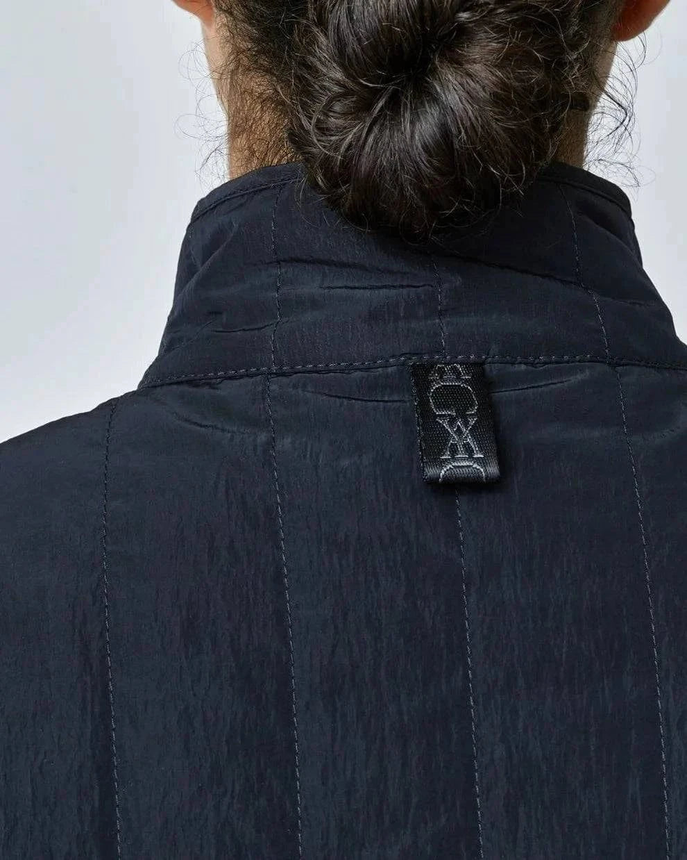 The Black Quilted Riding Vest offers a boxy silhouette with a stand-up collar, front zipper, and placket with easy press studs. The exterior is both wind-proof and water-repellent while Primaloft Padding insulates to provide optimal warmth throughout your ride. Feature two front pockets, two invisible side seam pockets, and an inner pocket. Cut from an Italian fabric, and sewn in Europe.