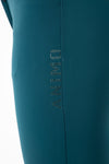 Deep Teal Women's high-waist breeches with knee grip. The waist has a two-button closure. Black ankle cuffs. Animo logo on outer thigh and design on waistband – both in rhinestones.